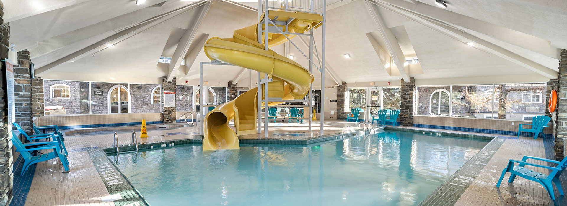 Indoor pool with yellow waterslide