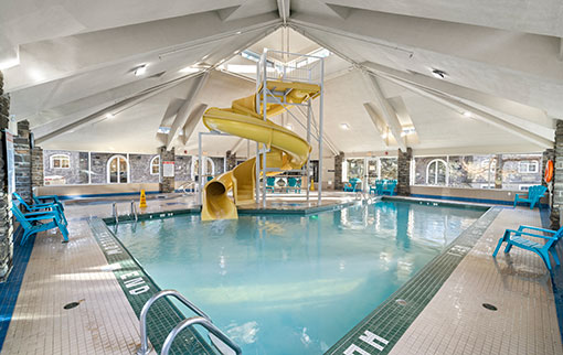 Indoor pool with yellow waterslide