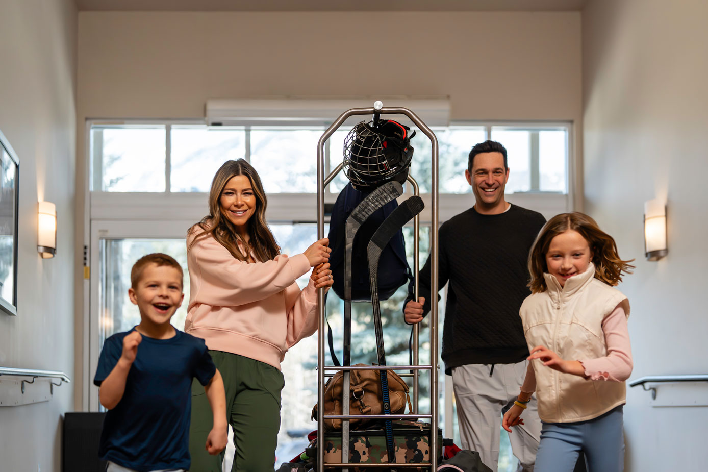 hockey family checking in at a hotel with luggage cart